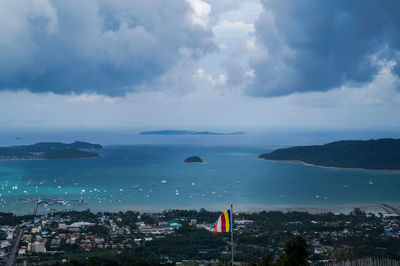 Scenic view of sea by city against sky