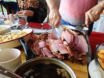 Woman carving ham