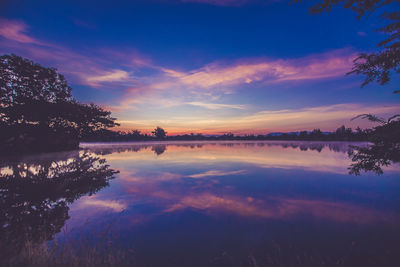 Scenic view of lake against sky during sunset