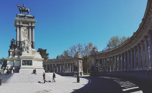 People at monument to alfonso xii in parque del buen retiro