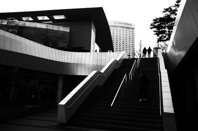 Low angle view of people walking on steps