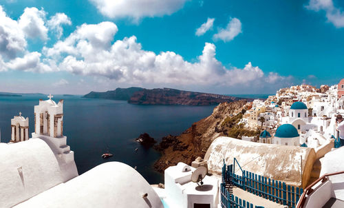 Panoramic view of buildings and sea against sky