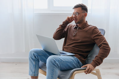 Young man using laptop at home