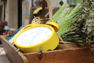 Close-up of alarm clock and vegetables on table
