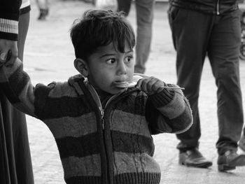 Boy with mother holding lollipop