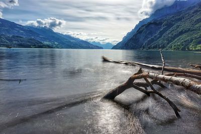 Scenic view of lake and mountains against sky