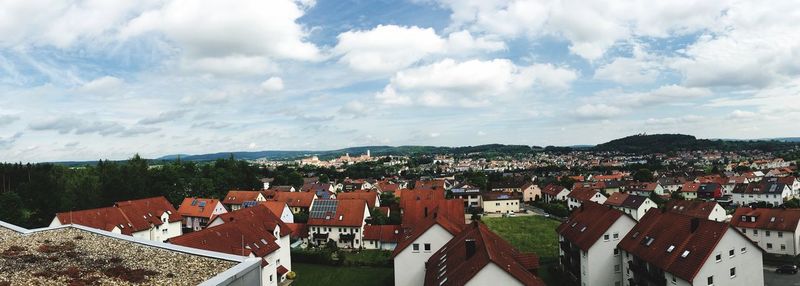 Aerial view of houses in town against sky