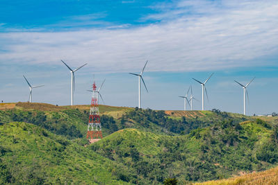 Windmill on field against sky