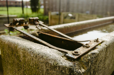 Close-up of old rusty wheel on field