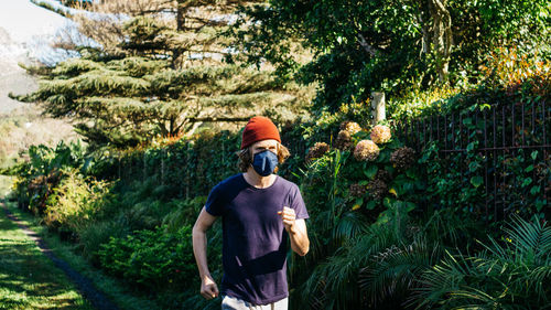 Man jogging against trees