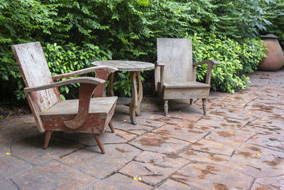 Empty chairs and table in park