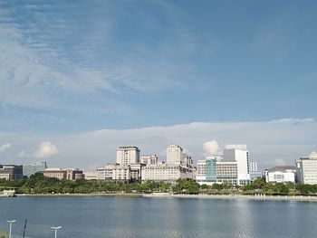 River by buildings against sky in city