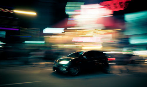 Blurred motion of car on city street at night
