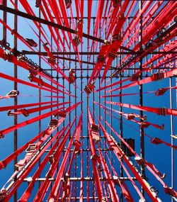 Low angle view of ferris wheel against blue sky