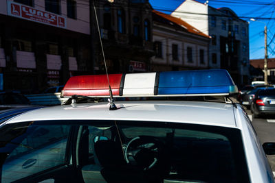 Cars on street against buildings in city