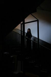 Woman standing in the dark