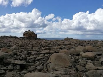 Rocks on beach against sky