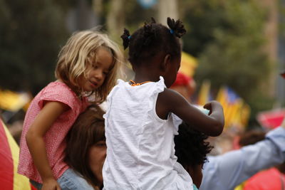 Children and girl looking at camera