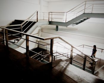 Woman moving down on steps in building