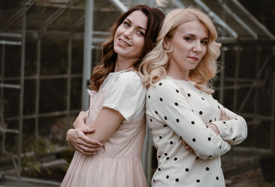 Two mature sisters in the garden in the evening. portrait of woman at her 40s and 30s, relatives