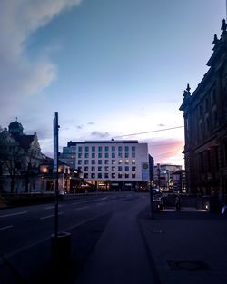 City street by buildings against sky