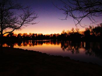 Scenic view of lake against sky at dusk