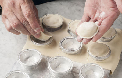 Cropped hands of chef preparing food on table in commercial kitchen