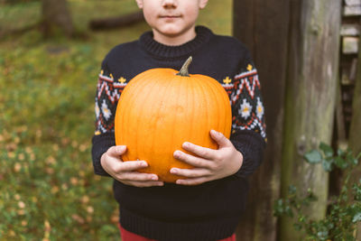 Close-up of a man holding pumpkin