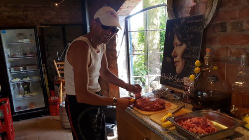 Midsection of man preparing food in kitchen