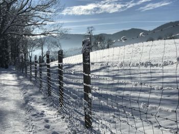 Snow covered field against sky