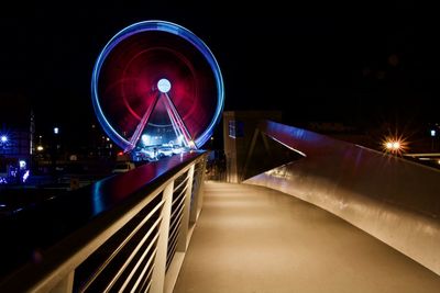 Illuminated ferris wheel at night