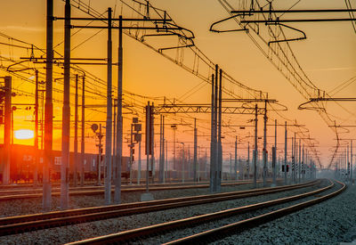 Train station with rails at sunset