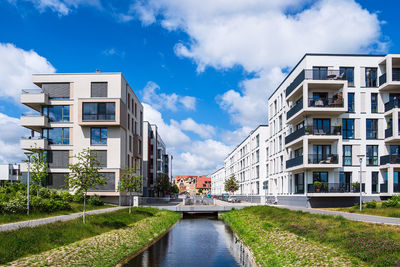 Canal amidst buildings against sky