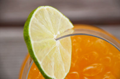 High angle view of lemon slice on glass with drink