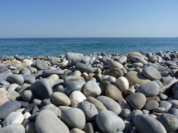 Rocks on shore against clear sky