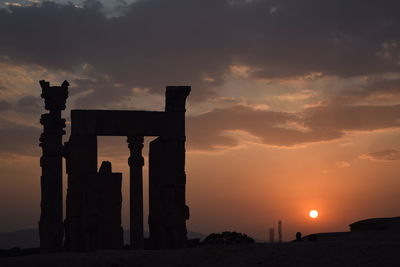 Low angle view of silhouette temple against sky during sunset