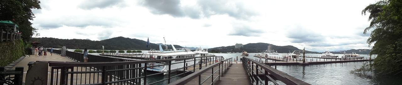 sky, built structure, water, cloud - sky, architecture, cloudy, building exterior, transportation, cloud, river, railing, nautical vessel, pier, the way forward, day, bridge - man made structure, mountain, connection, outdoors, nature