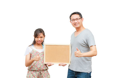 Portrait of a smiling young woman against white background