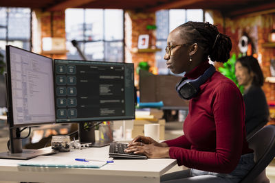 Side view of man working in office