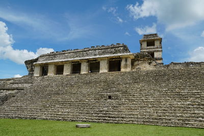 Low angle view of old building against cloudy sky