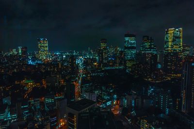 High angle view of illuminated buildings against sky at night