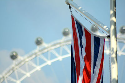 Low angle view of flags against clear sky