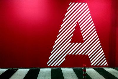 Symbol on the wall of underground garage parking lot section, abstract urban bacground