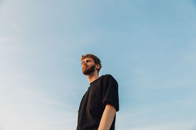 Low angle view of man standing against sky