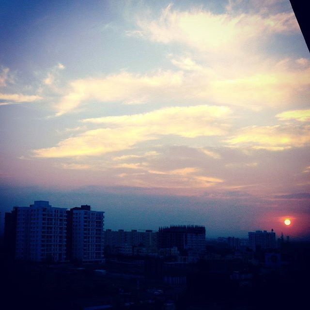 VIEW OF CITYSCAPE AGAINST SKY AT SUNSET