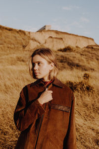 Portrait of young woman standing in desert