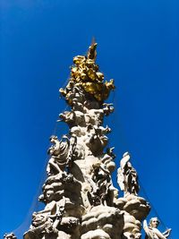 Low angle view of statue against blue sky