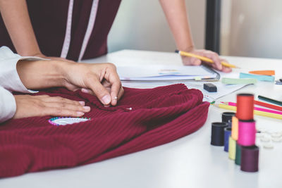 Cropped image of fashion designers working in studio