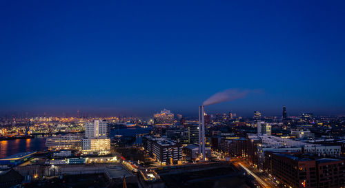 High angle view of illuminated city buildings at dusk