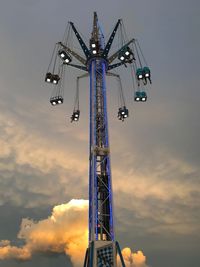 Low angle view of ferris wheel against sky during sunset